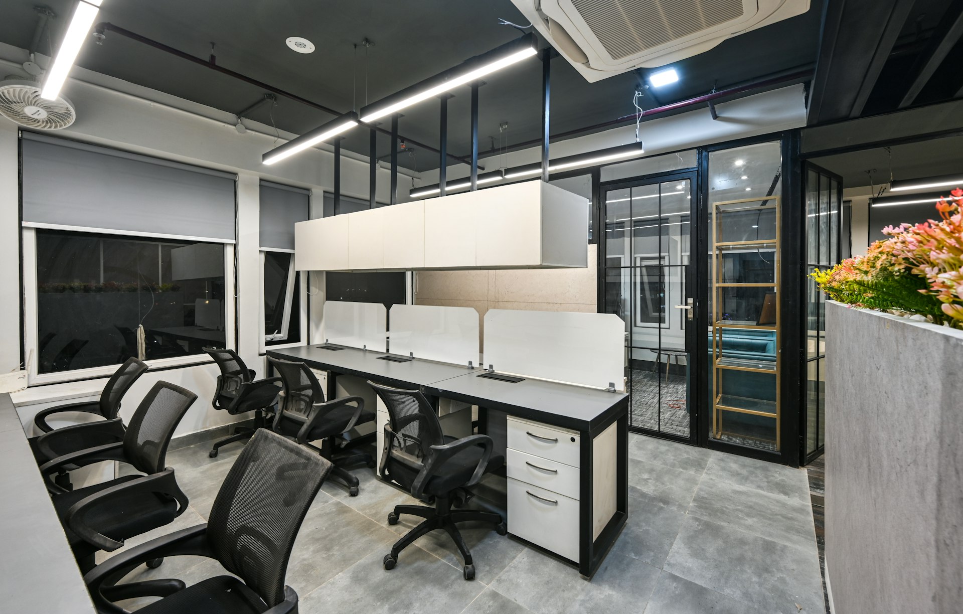 an office with a large white table and chairs